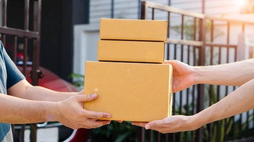 Handing off of 3 cardboard boxes